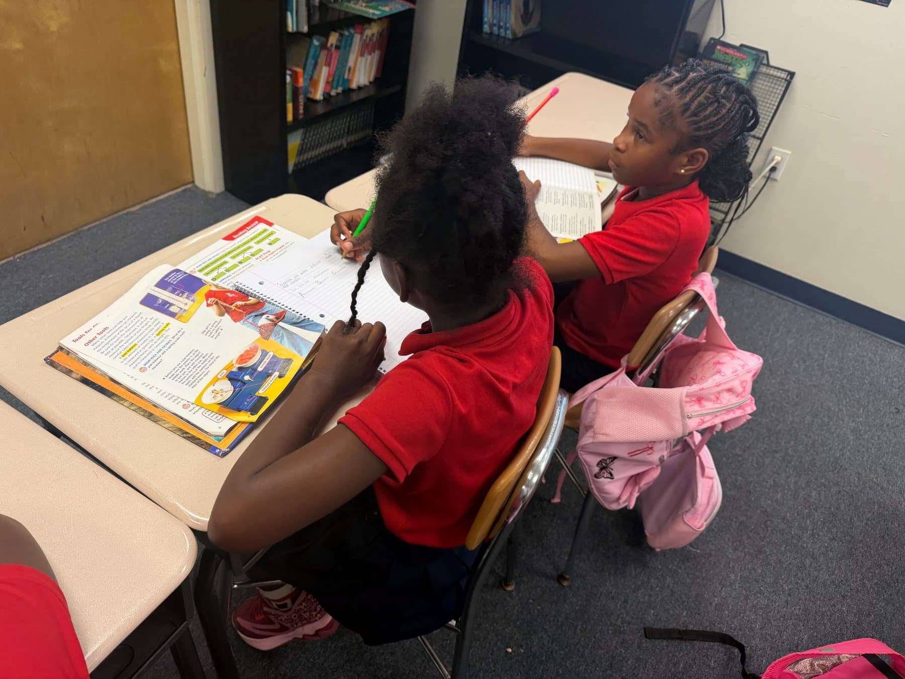 Students working closely together in a Saint Peter’s Academy classroom.