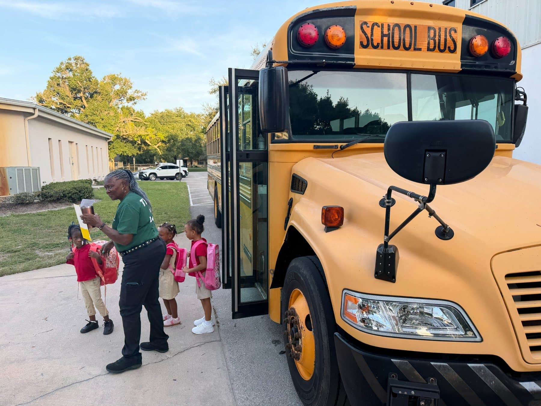 A student exiting a Saint Peter’s Academy school bus.