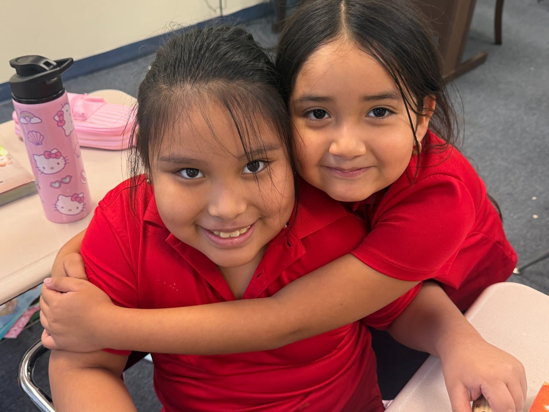 Two Saint Peter’s Academy students smiling together.