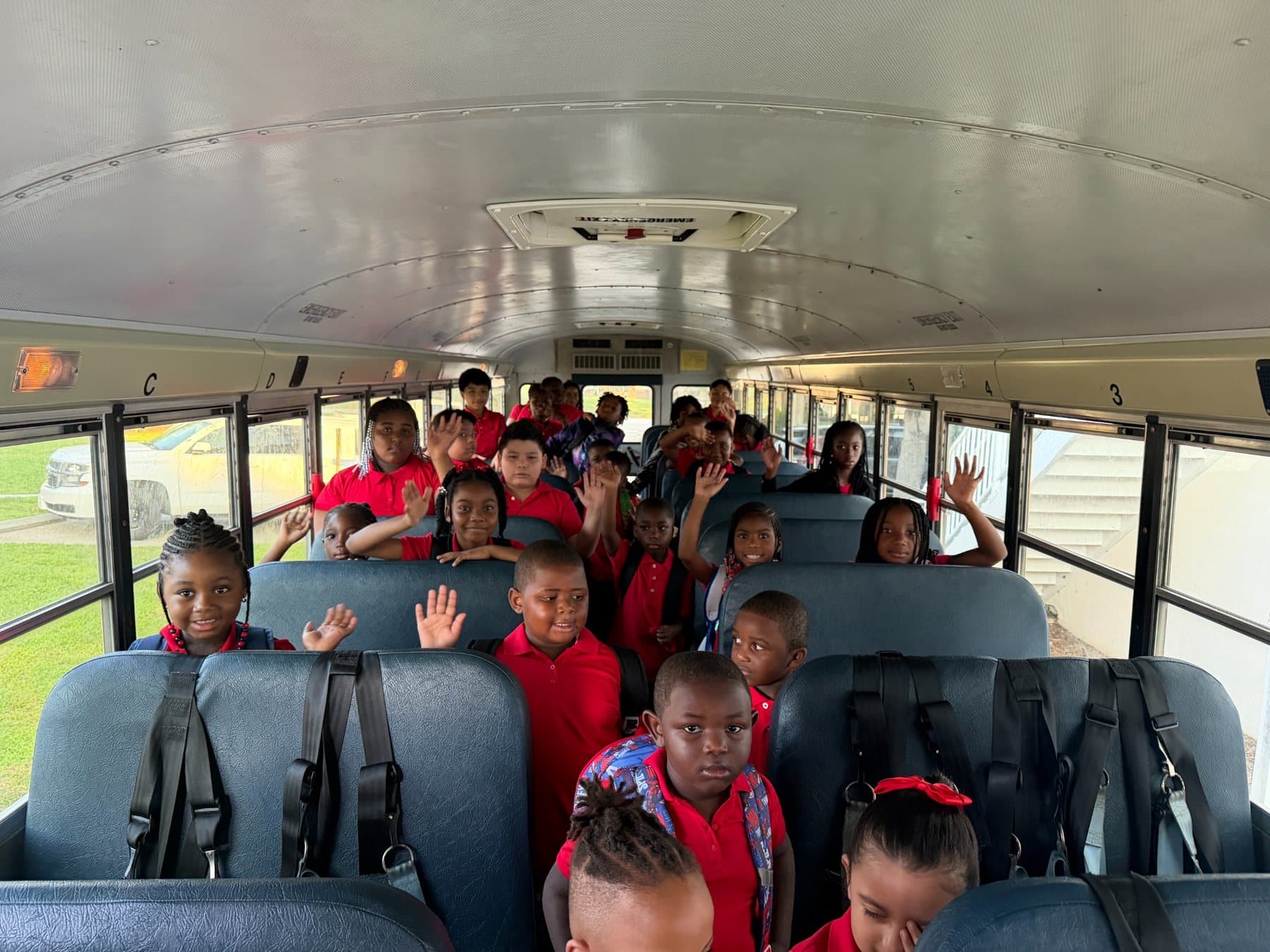 A Saint Peter’s Academy student waving during dismissal.